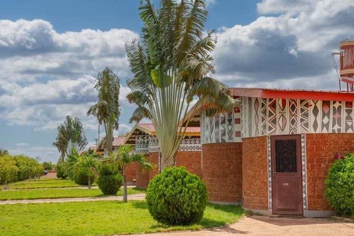 Palm trees beside a patterned accommodation building