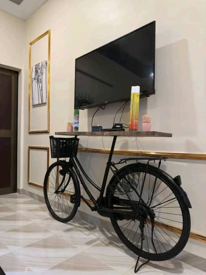 Villa interior with a television, console furniture and decorative bicycle