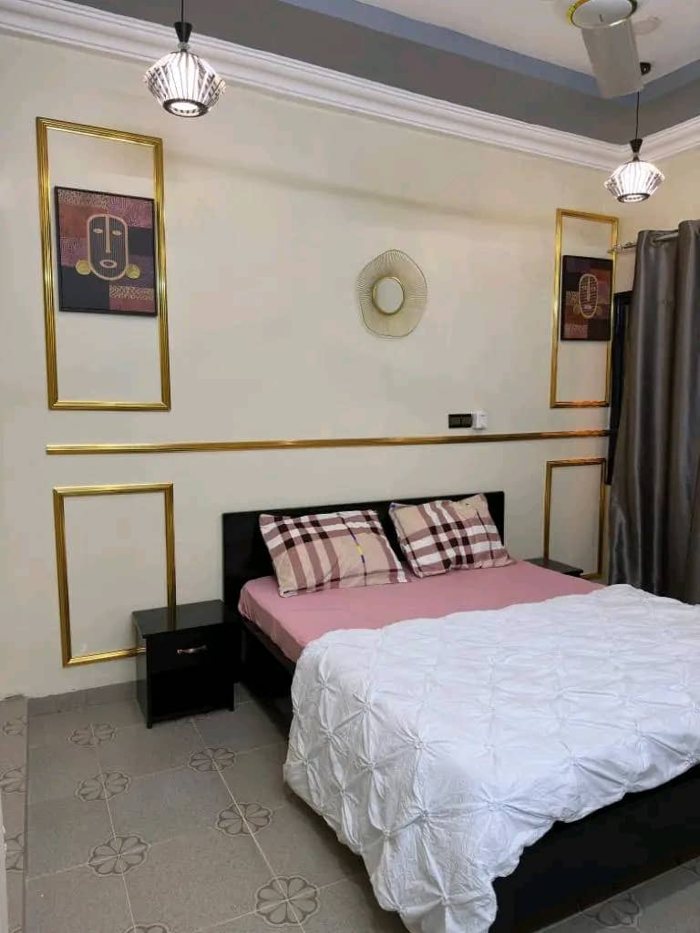 Furnished villa bedroom with a double bed, soft lighting and curtains