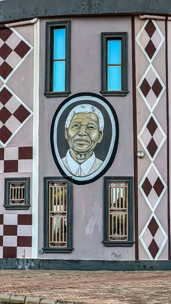 Nelson Mandela portrait displayed on a decorated building in Burkina Faso