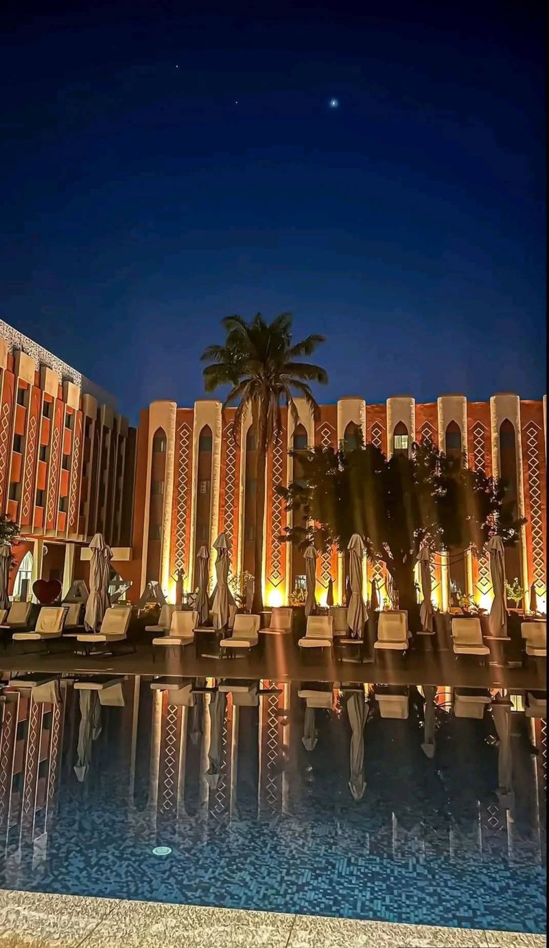 Illuminated architecture and reflecting pool in Ouagadougou at night