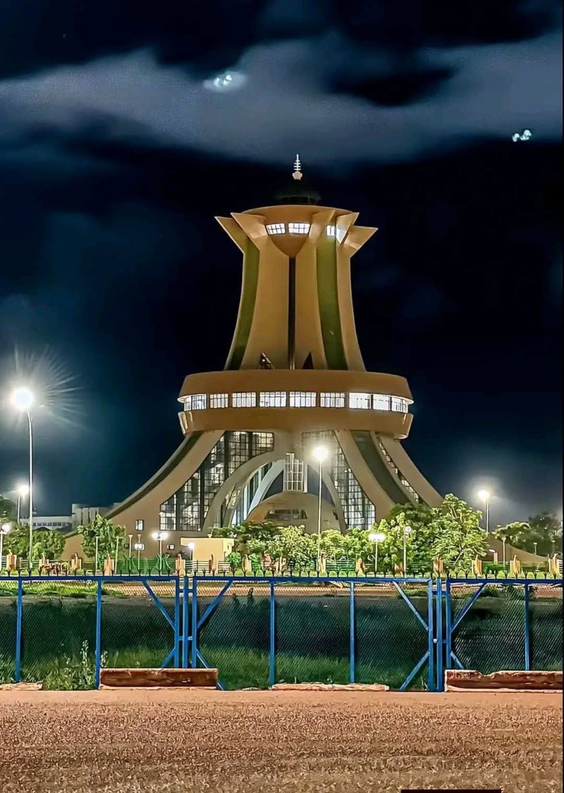 A landmark roundabout illuminated at night in Ouagadougou